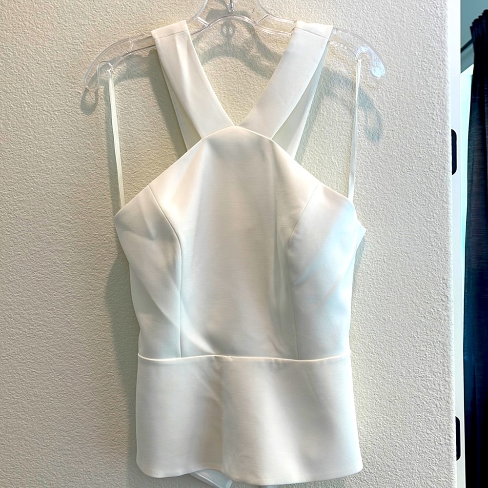 BCBG High neck, open back peplum top.